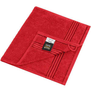A red guest towel with a textured surface and a folded corner featuring a tag, showcasing a simple design.