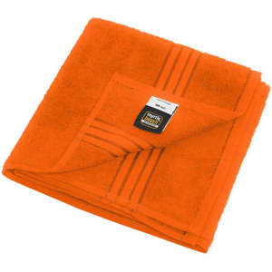 An orange hand towel with a folded design and a tag, featuring stripes along the edge.
