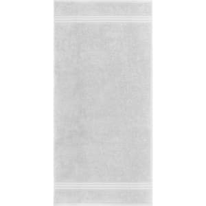 A hand towel in soft grey with white trim details. The towel has a simple, elegant design and branding.