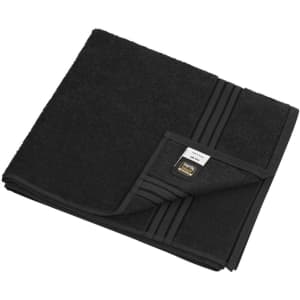 A black bath towel featuring a textured pattern and a label. It is neatly folded.