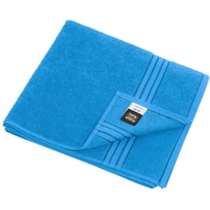 A blue bath towel with a textured design and a branding label on the corner.
