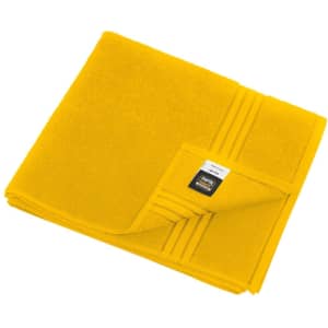 A yellow bath towel with a textured finish and a folded corner, featuring a brand logo.