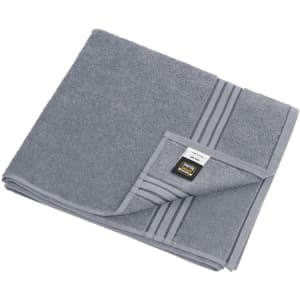 A grey bath towel with a folded corner, featuring striped detailing and a small logo label.