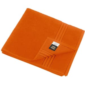 An orange bath towel with a folded corner and a logo on the edge. Soft, plush texture.