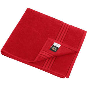 A red bath towel with a textured finish and a folded edge, featuring a logo on the corner.