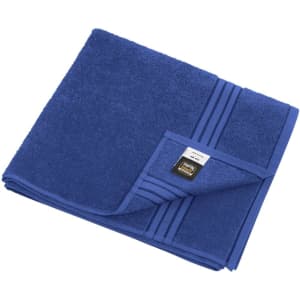 A blue bath towel with a textured surface and a logo on the folded corner.