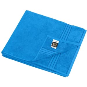 A blue sauna sheet folded neatly, featuring a textured surface and a small tag on the edge, with a logo.