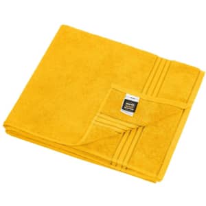A folded yellow sauna sheet made of soft towel-like fabric, featuring a logo tag on one corner.