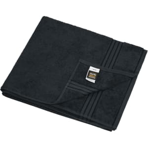 A black sauna sheet folded neatly, featuring a textured surface and a tag in one corner.