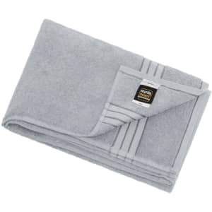 A folded grey bath sheet with a decorative stripe and a logo tag. Soft texture visible.