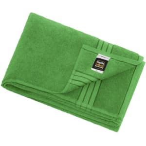 A green bath sheet with a folded corner, featuring a tag and textured detailing on one side.