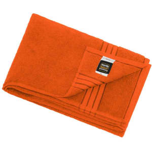 An orange bath sheet, folded neatly with a tag featuring a logo. Soft texture and a vibrant colour.