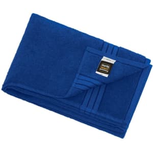 A blue bath sheet neatly folded with a label, featuring a textured design on one edge.