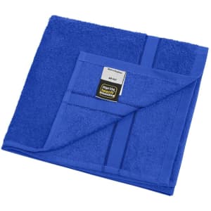 A blue hand towel with a textured surface and a label, folded neatly.