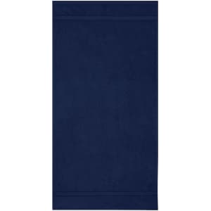 A navy hand towel with a soft texture, featuring a simple design and a branded logo.