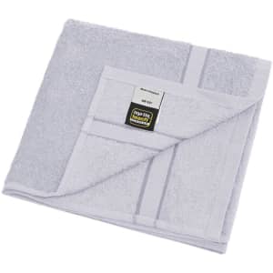 A light grey hand towel neatly folded, featuring a stitched edge and a logo on the tag.
