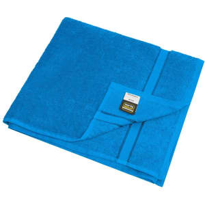 A turquoise bath towel folded neatly with a tag attached. The fabric appears soft and plush.