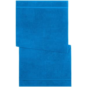 A bright blue bath towel featuring a textured design and subtle stripes. The towel displays a logo.