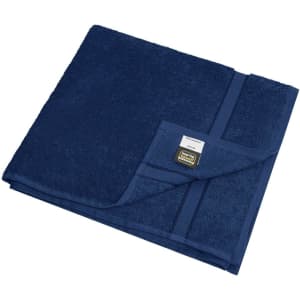 A navy blue bath towel featuring a textured surface and a corner label, folded neatly.