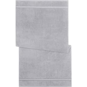 A grey bath towel with a textured design and a subtle striped pattern. Features a logo on the corner.