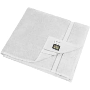 A white bath towel with a folded design and a label, featuring a subtle textured pattern.