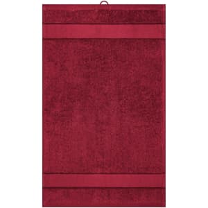A deep red guest towel with textured stripes and a hanging loop. The towel has a branding label.