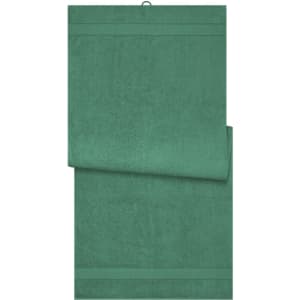 A green sauna sheet with a textured finish, featuring a hanging loop and folded at one corner.