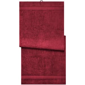 A deep red sauna sheet with a smooth texture, featuring a simple design and a hanging loop.