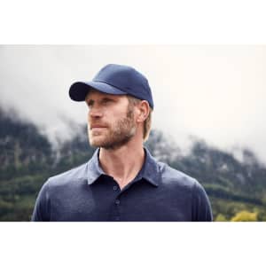 A navy blue polyester peach cap with a six-panel design, set against a scenic mountain backdrop.