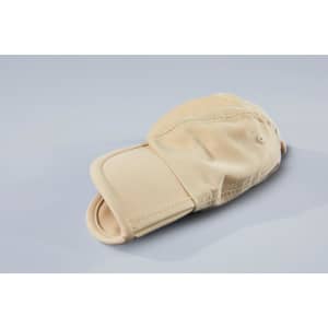 A beige 6 Panel Pack-a-Cap laying flat, featuring a curved brim and a branded logo.