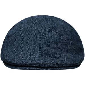 A navy blue Dandy Cap featuring a herringbone pattern and a rounded shape. It has a logo on the side.