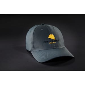 A grey six-panel workwear cap with a logo featuring a construction helmet.