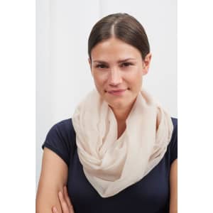 A light beige scarf wrapped around a model’s neck, featuring a soft, flowing design and subtle texture.