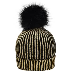 A striped metallic beanie in gold and black featuring a black pom pom on top. It has a logo on the band.