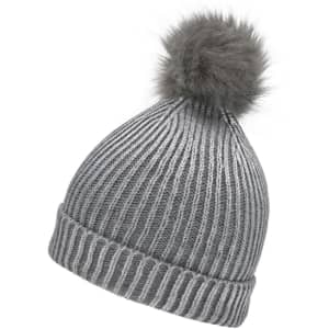 A grey metallic beanie with a fluffy pom-pom on the top. Features a ribbed texture and includes a logo.