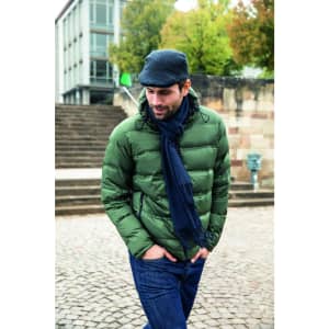 A man in a green puffer jacket and dark scarf walks on cobblestone steps. The scarf has a subtle fringe detail.