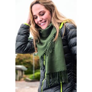 An elegant green scarf draped around a smiling woman, paired with a puffy black jacket.