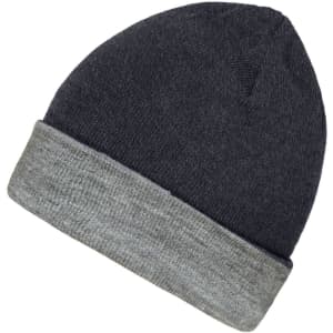 A beanie featuring a reversible design with a dark top and light grey cuff. It has a logo on the side.
