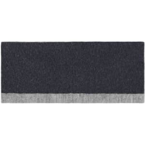 A reversible headband featuring a dark grey design with a lighter grey trim, displaying a simple logo.