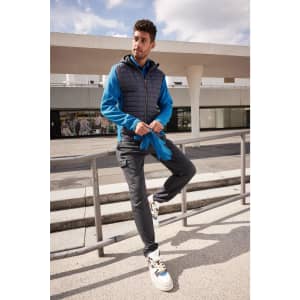 Fleece gloves in bright blue, displayed alongside a model wearing a blue and grey jacket, with casual pants and shoes.