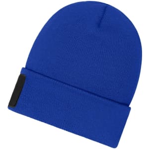 A blue beanie with a patch, featuring a snug fit and a folded cuff design.