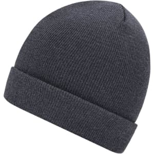 A knitted beanie in dark grey, featuring a ribbed texture and a folded cuff. It has a simple logo on the side.