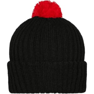 A black knitted beanie with a red pompon on top and a ribbed design. It features a branding logo.