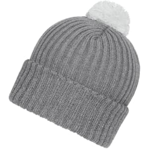 A grey knitted beanie with a white pompon on top, featuring ribbed detailing. It has a logo on it.