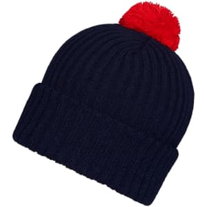 A navy knitted beanie with a red pompon on top and a ribbed design. The beanie includes a branding logo.