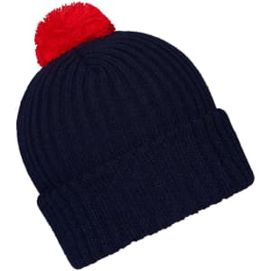 A navy knitted beanie with a red pompon on top, featuring a ribbed design and a folded cuff.