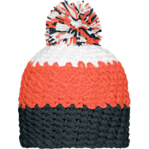 A knitted beanie in orange, white, and navy blue with a pompon on top. It features a logo.