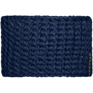 A dark blue crocheted headband with a textured pattern and a small branding tag.