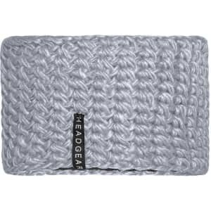 A crocheted headband in a soft grey colour, featuring a small branding label on one side.