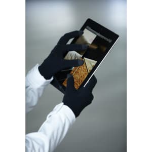 Black touch-screen knitted gloves are used to operate a tablet device, showcasing a sleek design.